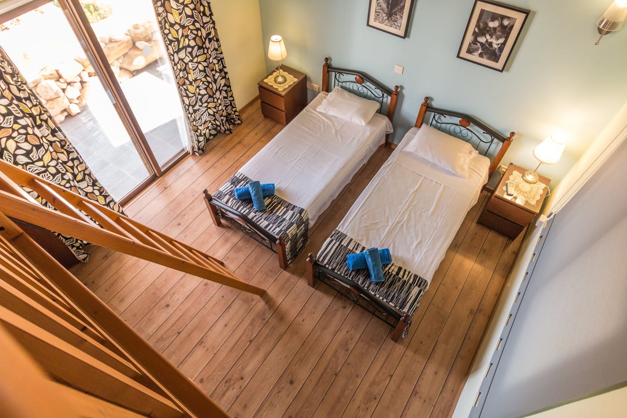 Two Beds in Room Beside Ladder