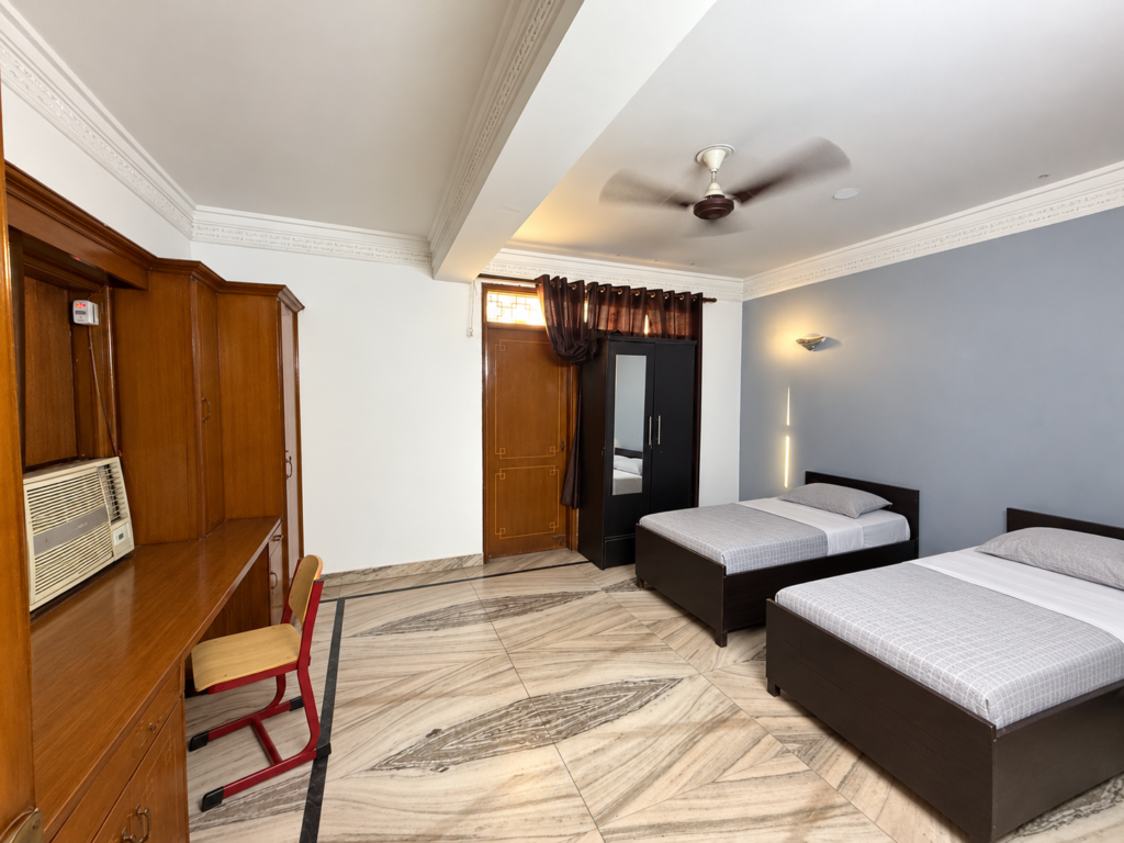 GableStay shared room with beds beside wooden wardrobes