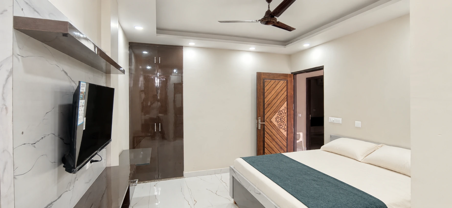 GableStay private room with a wardrobe, television and neatly styled bed